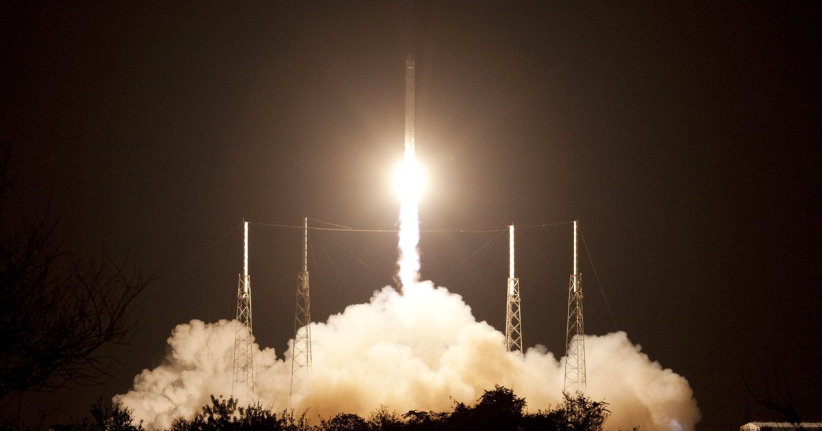A SpaceX rocket lifts off against a clear sky